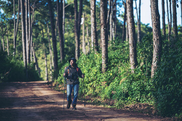 Obraz premium Young Man Traveler with backpack relaxing outdoor with rocky mountains on background Summer vacations and Lifestyle hiking concept.