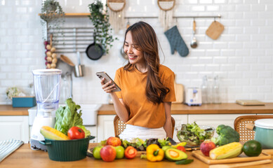 Portrait of beauty body slim healthy asian woman having fun cooking and preparing cooking vegan food healthy eat with fresh vegetable salad on counter in kitchen at home.Diet.Fitness, healthy food