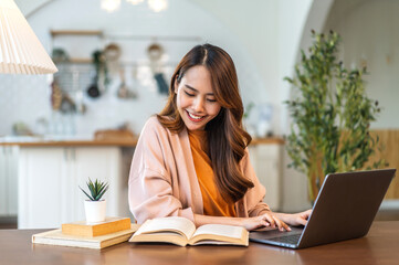 Young smiling asian woman happy relax use laptop conference work,learning education, shopping, study online, webinar, podcast,creative girl feel good, positive, success, excited, surprised at home