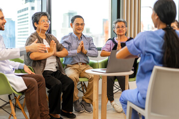 Portrait of asian woman physiotherapist trainer carer help physical and discussing consulting with group asian senior patient by doing yoga workout exercises in rehabilitation at hospital.healthcare
