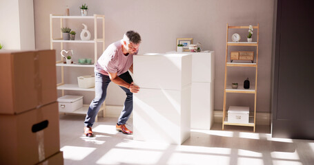 Man Carrying Furniture At Home