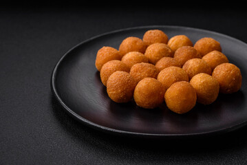 Delicious fried potato balls with breaded mozzarella, salt, spices and herbs