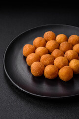 Delicious fried potato balls with breaded mozzarella, salt, spices and herbs