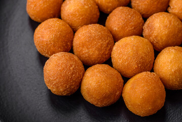 Delicious fried potato balls with breaded mozzarella, salt, spices and herbs