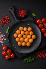 Delicious fried potato balls with breaded mozzarella, salt, spices and herbs