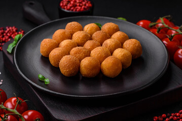 Delicious fried potato balls with breaded mozzarella, salt, spices and herbs