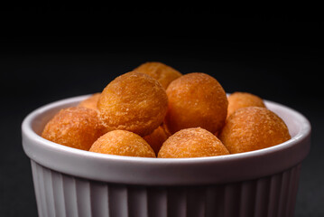 Delicious fried potato balls with breaded mozzarella, salt, spices and herbs