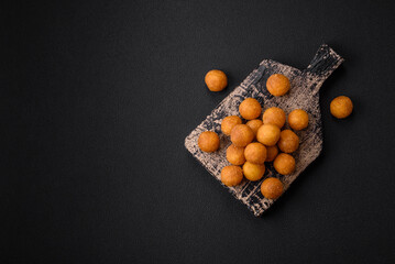 Delicious fried potato balls with breaded mozzarella, salt, spices and herbs