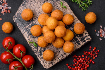 Delicious fried potato balls with breaded mozzarella, salt, spices and herbs