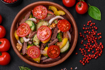 Delicious fresh salad with beef slices, cherry tomatoes, sweet peppers