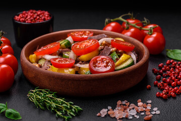 Delicious fresh salad with beef slices, cherry tomatoes, sweet peppers