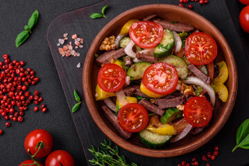 Delicious fresh salad with beef slices, cherry tomatoes, sweet peppers