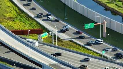 Above view of wide highway crossroads in Miami, Florida with slow driving cars during rush hour. USA transportation infrastructure concept