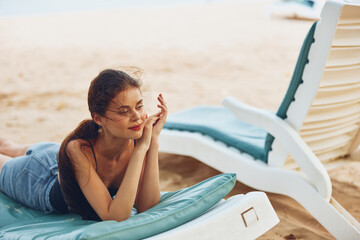 woman smiling lying sunbed sea ocean sand travel lifestyle resort beach