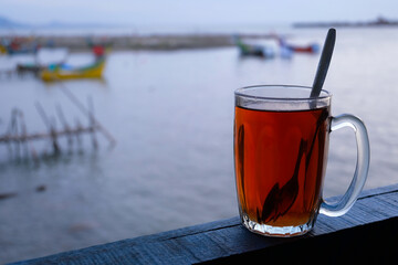 a glass of hot tea on the beach