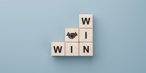 Win win wording with hand shaking icon on wooden cube block. win-win in business concept for...