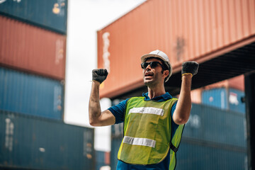 Portrait of Smiling Professional Heavy Industry Engineer  Worker Wearing Safety Uniform and Hard Hat. In the Background container Industrial Factory shipment