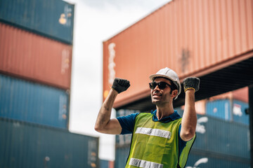 Portrait of Smiling Professional Heavy Industry Engineer  Worker Wearing Safety Uniform and Hard Hat. In the Background container Industrial Factory shipment