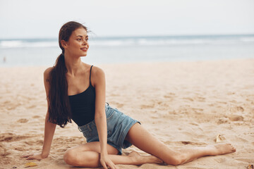 Fototapeta na wymiar fashion woman sand vacation sitting freedom travel beach sea nature smile