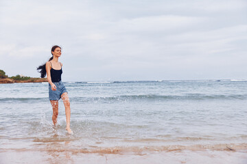 Fototapeta premium summer woman beach space copy running young sunset travel smile lifestyle sea