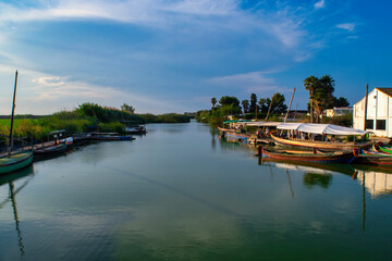 Fototapeta na wymiar Sunset in the famous lagoon of Valencia. Dock for traditional boats. Walks along the lagoon