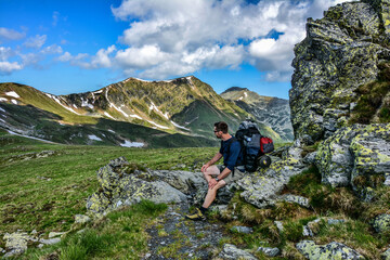 Fototapeta na wymiar Young man trekking beautiful mountain
