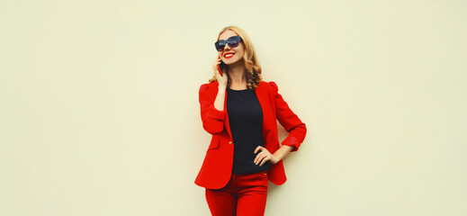 Beautiful elegant lady woman calling on smartphone wearing red business blazer on white background