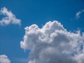 White fluffy clouds in the deep blue sky background