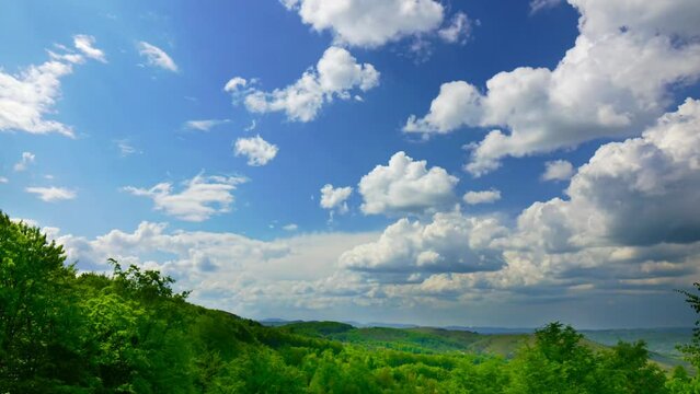 Nature landscape cumulus clouds rolling over hills and mountains time-lapse