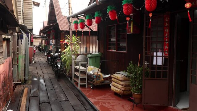 Georgetown, Malaysia - April 20, 2023: Chew Jetty UNESCO Chinese settlement listed with Chew clan wooden paths, colorful street art and buildings. It is known for its traditional food and shops.