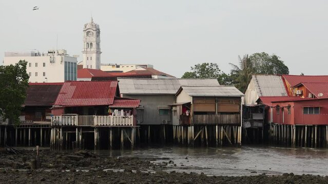 Georgetown, Malaysia - April 20, 2023: Chew Jetty UNESCO Chinese settlement listed with Chew clan wooden paths, colorful street art and buildings. It is known for its traditional food and shops.