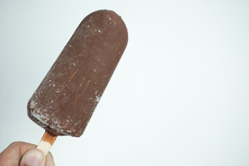 hand holding Chocolate Ice cream  bar isolate on white background