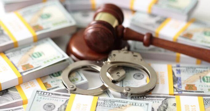 Judge gavel handcuffs and banknotes dollars. Economic crime and collateral fraud and corruption