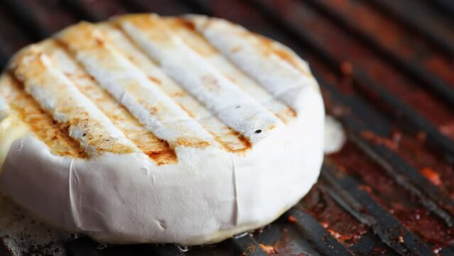 fry camembert cheese on an electric grill. appetizing fried camembert cheese. vegan food. handheld video