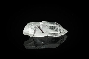 quartz rod with black tourmaline (schorl)  isolated on black background. macro detail close-up...