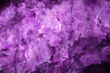 purple fluorite crystal backlit. macro detail texture background. close-up raw rough unpolished...