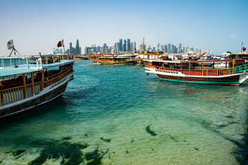 Obraz premium Doha Old Ships, Sailboats of Qatar with a panoramic view of the Skyline at Doha Corniche 