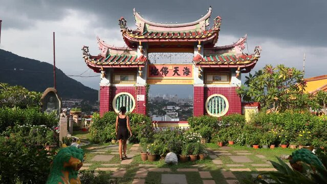 A tourist girl walks around the grounds of the Kek Lok Si temple in George Town, Penang