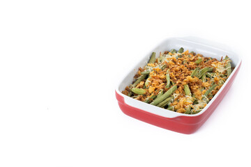 A traditional green bean casserole topped with French Fried Onions and cream of mushroom isolated on white background. Copy space