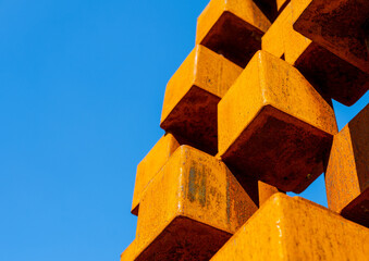metal rusty cubes on blue sky background