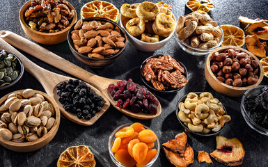 Composition with a variety of dried fruits and assorted nuts.