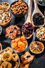 Composition with a variety of dried fruits and assorted nuts.