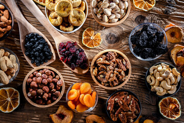 Composition with a variety of dried fruits and assorted nuts.
