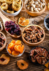 Composition with a variety of dried fruits and assorted nuts.