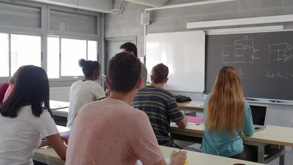 Group of diverse teenage students and a male teacher in class. High school, back to school - Powered by Adobe