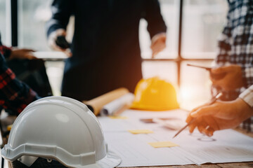 Engineer teams meeting working together wear worker helmets hardhat on construction site in modern...