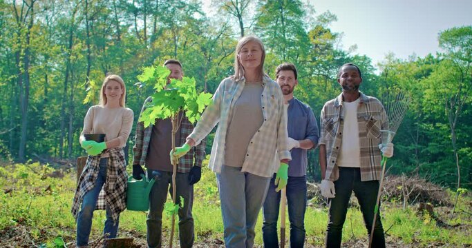 Ethnic diversity of eco-friendly volounteers. Multicultural team of volunteers help with solving environmental problems. Charitable activities for restoration of natural ecosystems