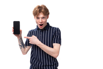 short-haired 25 year old blond male with tattoos in a striped polo showing ads on the phone