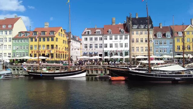 COPENHAGEN, DENMARK, July 9, 2023: Copenhagen iconic view. Famous old Nyhavn port in the center of Copenhagen, Denmark.
