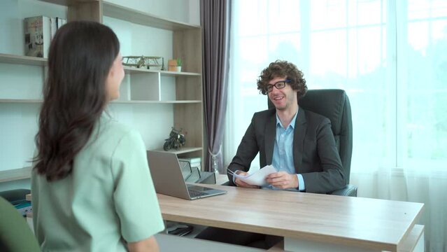 good looking Asian young woman having a job interviewing with the senior managing director in meeting room.